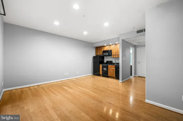 a kitchen with granite countertop a refrigerator and a sink