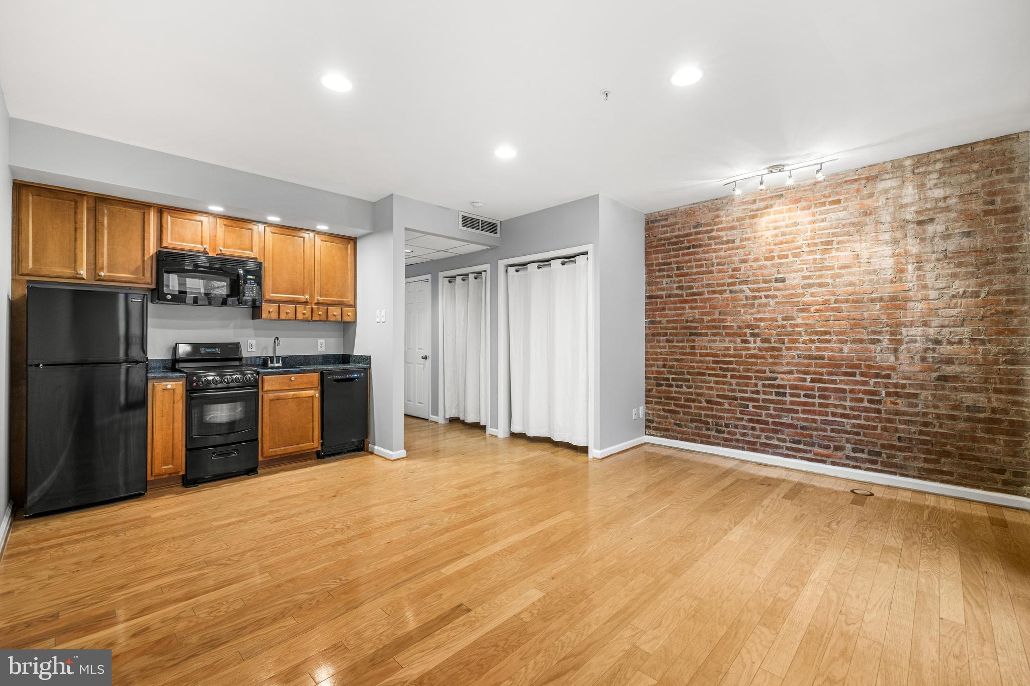 1000 Fell Street, Unit 421 Baltimore, MD 21231 - Photo 20 of 32 a view of kitchen with refrigerator and wooden floor