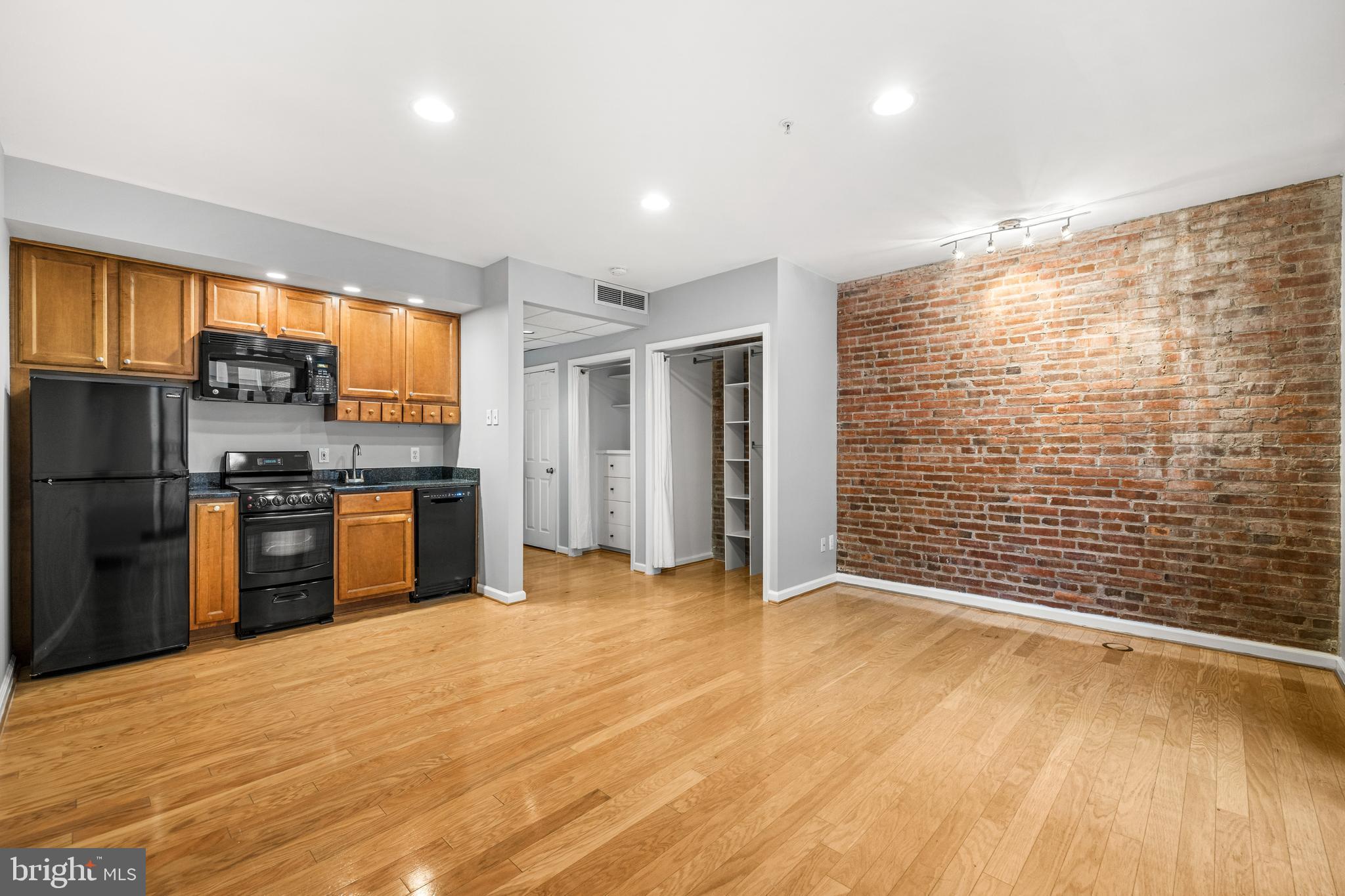 1000 Fell Street, Unit 421 Baltimore, MD 21231 - Photo 21 of 32 a view of kitchen with refrigerator and wooden floor