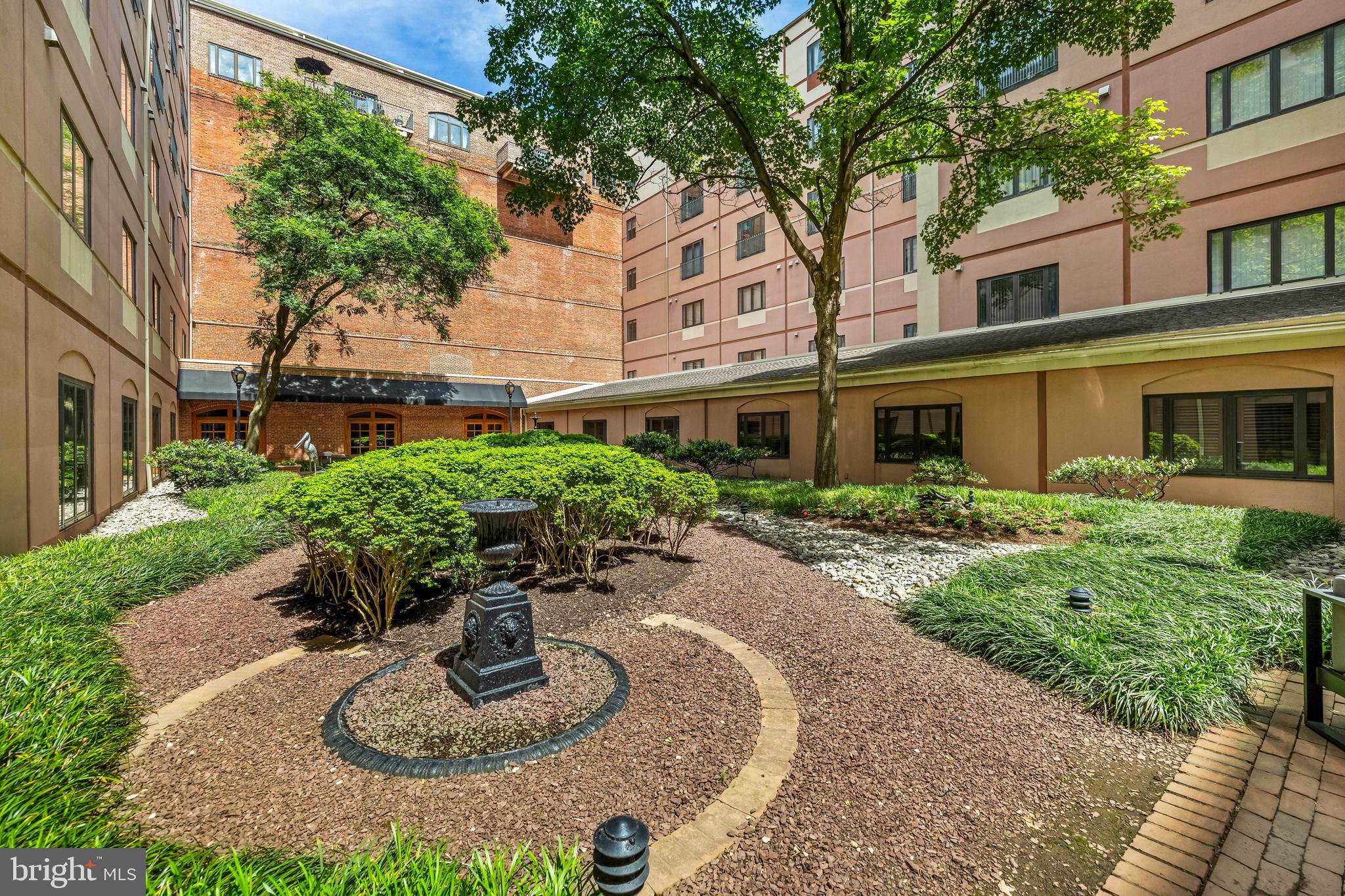 1000 Fell Street, Unit 421 Baltimore, MD 21231 - Photo 26 of 32 a flower garden with potted plants and big trees