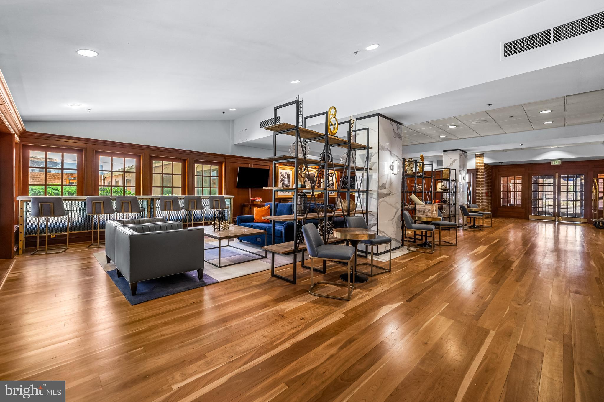 1000 Fell Street, Unit 421 Baltimore, MD 21231 - Photo 6 of 32 a living room with couches and kitchen view with wooden floor