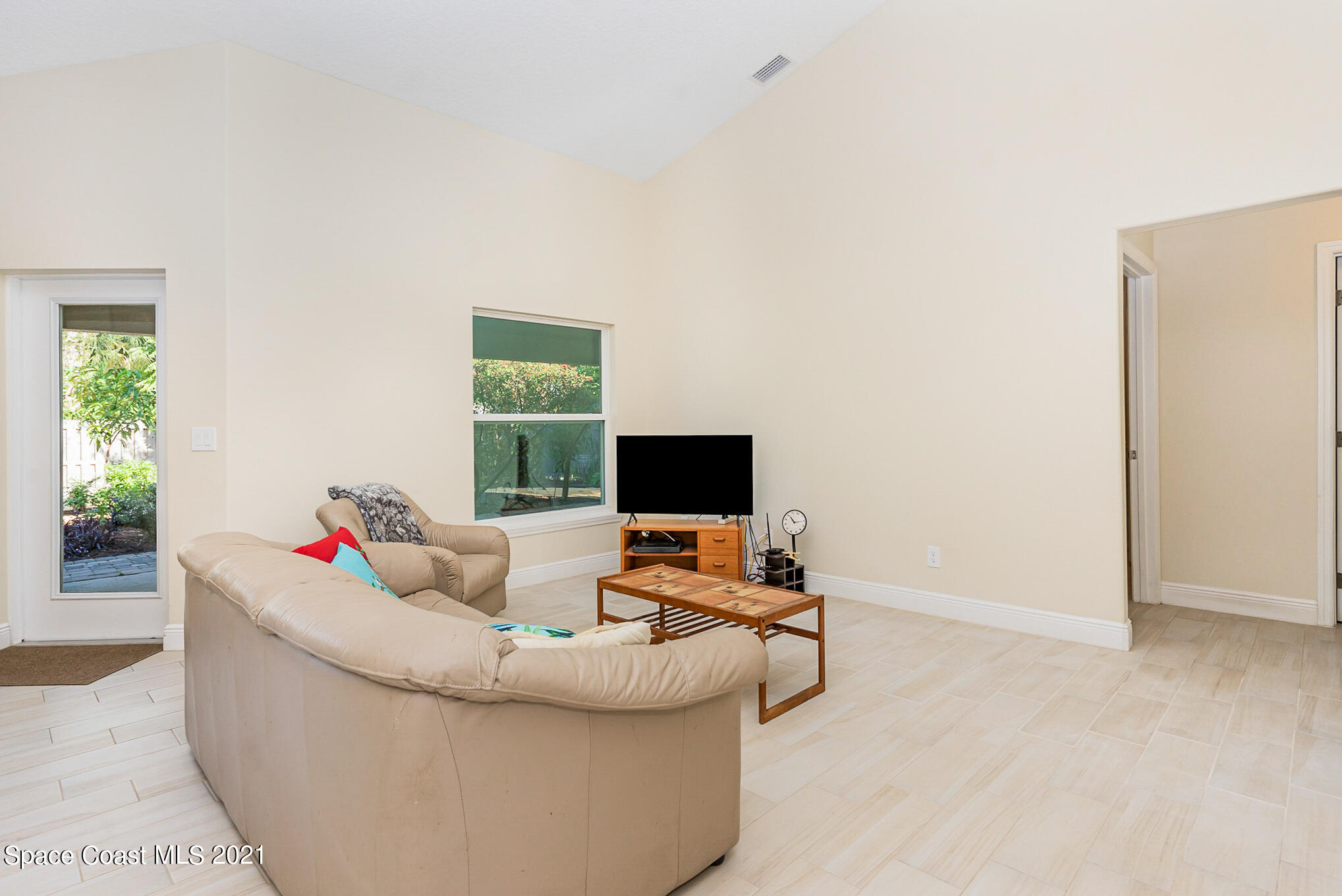 5576 Flint Road Cocoa, FL 32927 - Photo 11 of 31 a living room with furniture and a flat screen tv