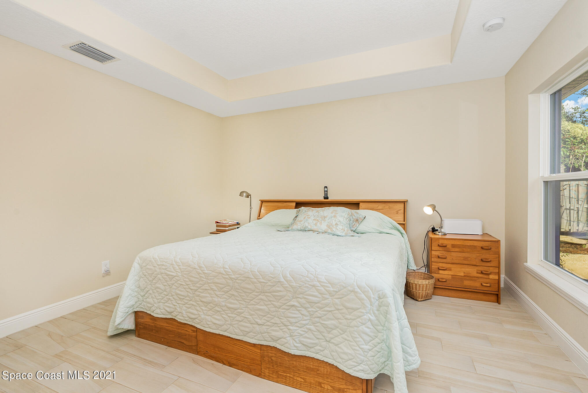 5576 Flint Road Cocoa, FL 32927 - Photo 12 of 31 a bedroom with a bed and a window