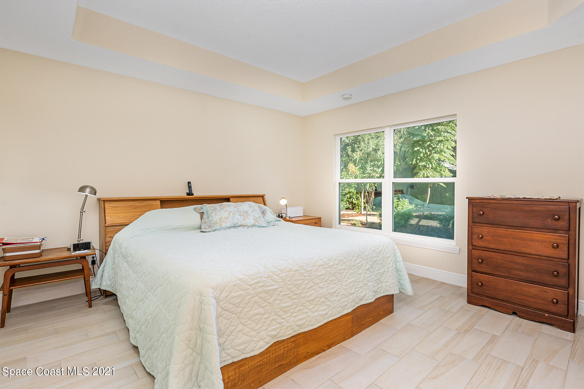 5576 Flint Road Cocoa, FL 32927 - Photo 13 of 31 a bedroom with a bed and a dresser