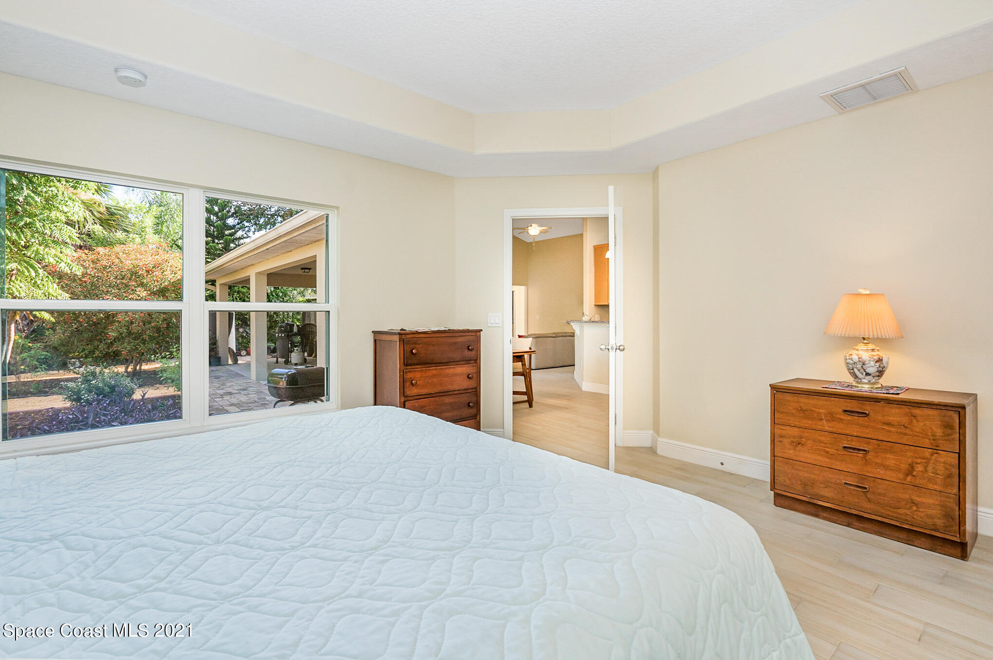 5576 Flint Road Cocoa, FL 32927 - Photo 14 of 31 a bedroom with a bed and wooden floor