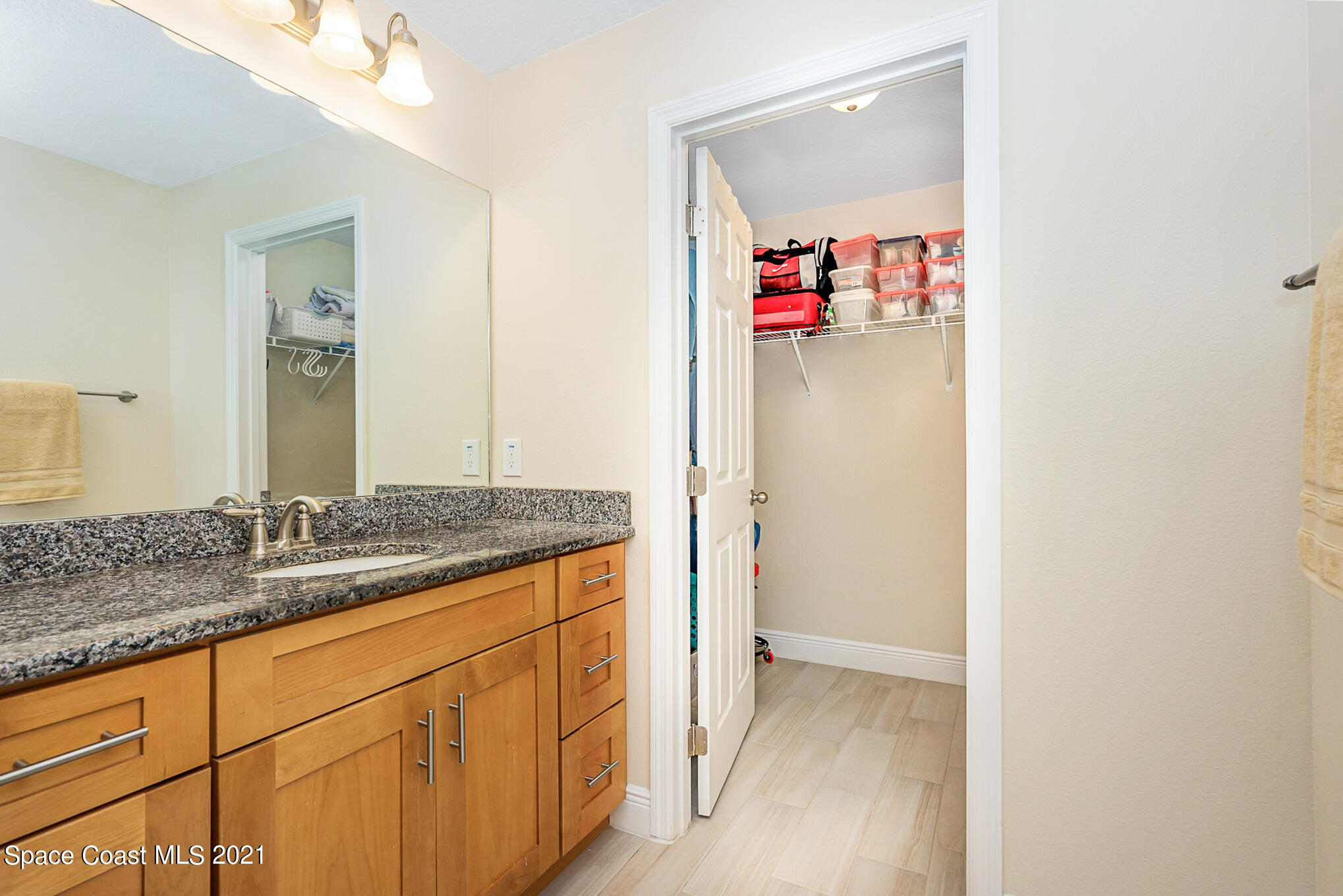 5576 Flint Road Cocoa, FL 32927 - Photo 15 of 31 a bathroom with a granite countertop sink and a mirror
