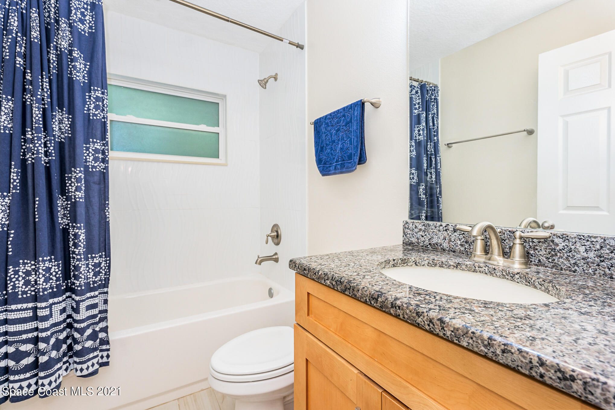 5576 Flint Road Cocoa, FL 32927 - Photo 22 of 31 a bathroom with a granite countertop sink and a mirror