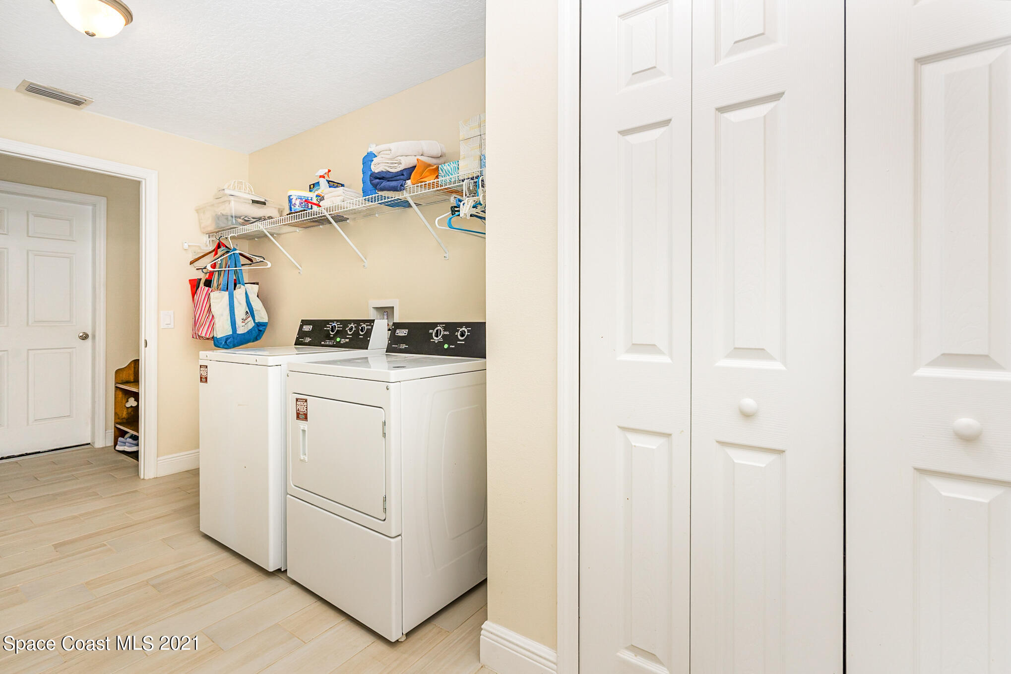 5576 Flint Road Cocoa, FL 32927 - Photo 23 of 31 a view of walk in closet with clothes and shoes