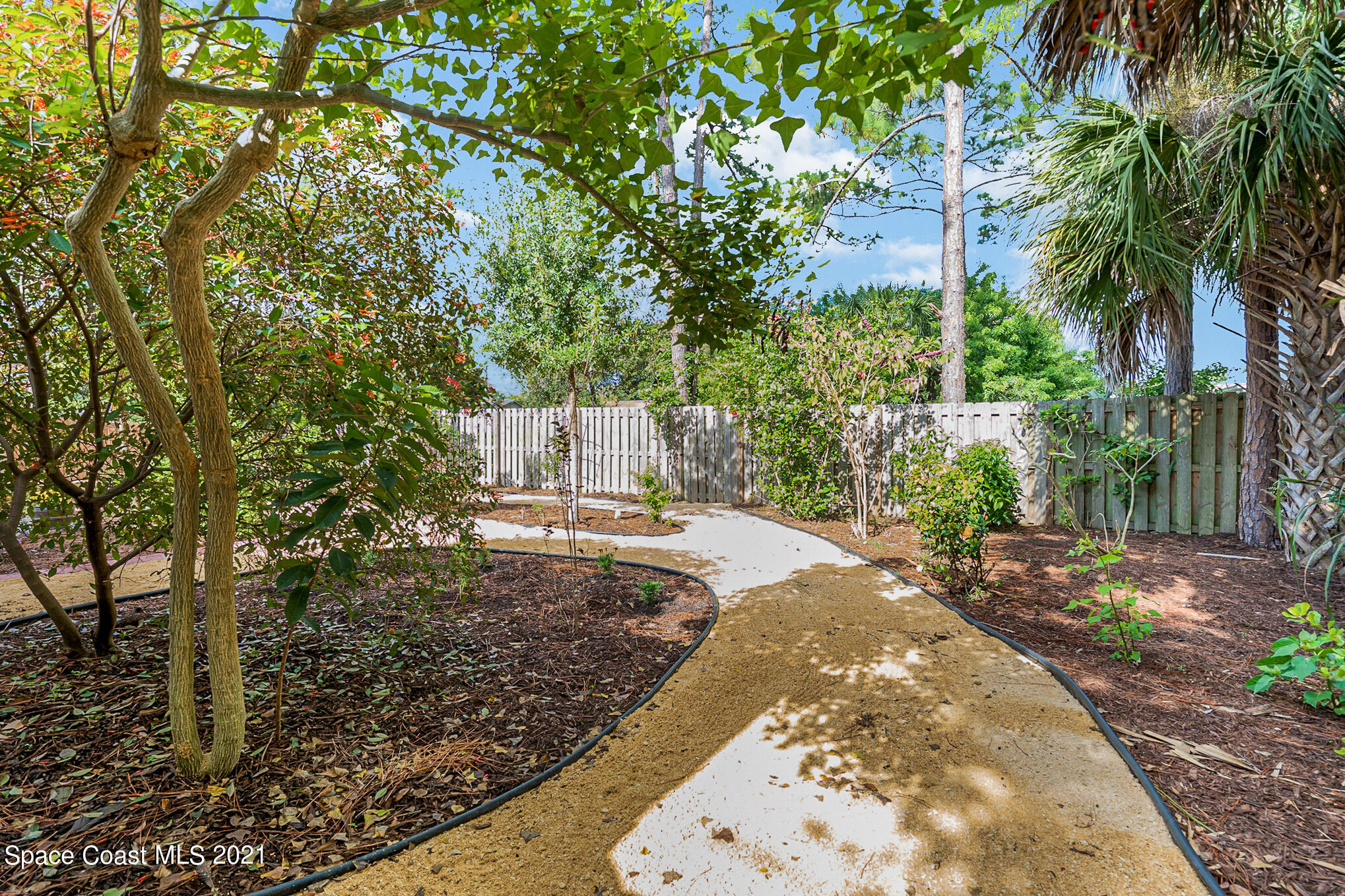 5576 Flint Road Cocoa, FL 32927 - Photo 28 of 31 a view of a backyard with large trees