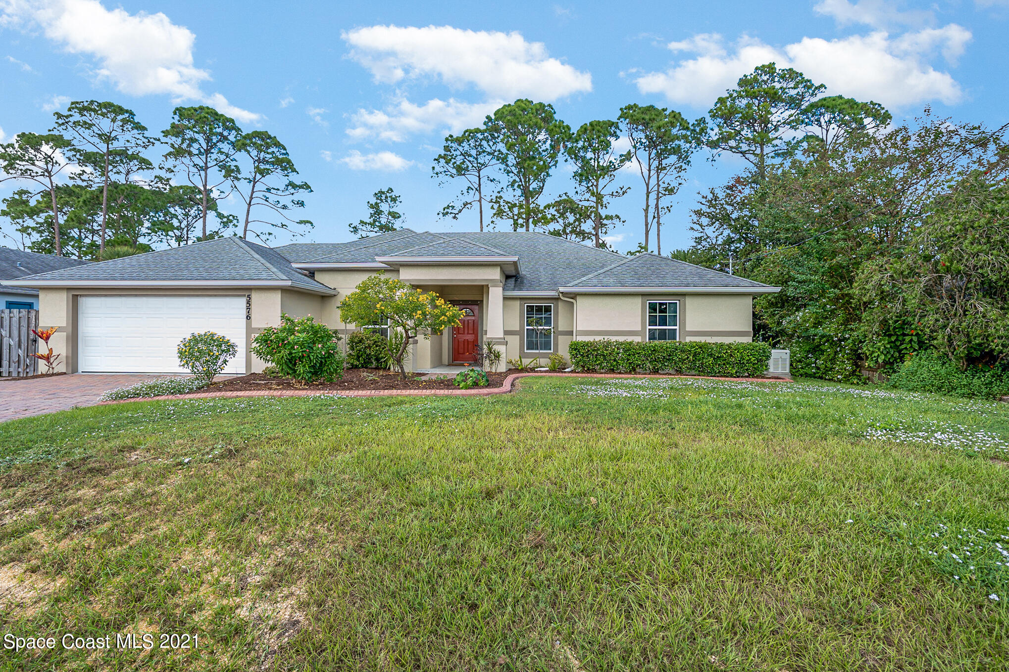 5576 Flint Road Cocoa, FL 32927 - Photo 30 of 31 a front view of a house with a yard and potted plants