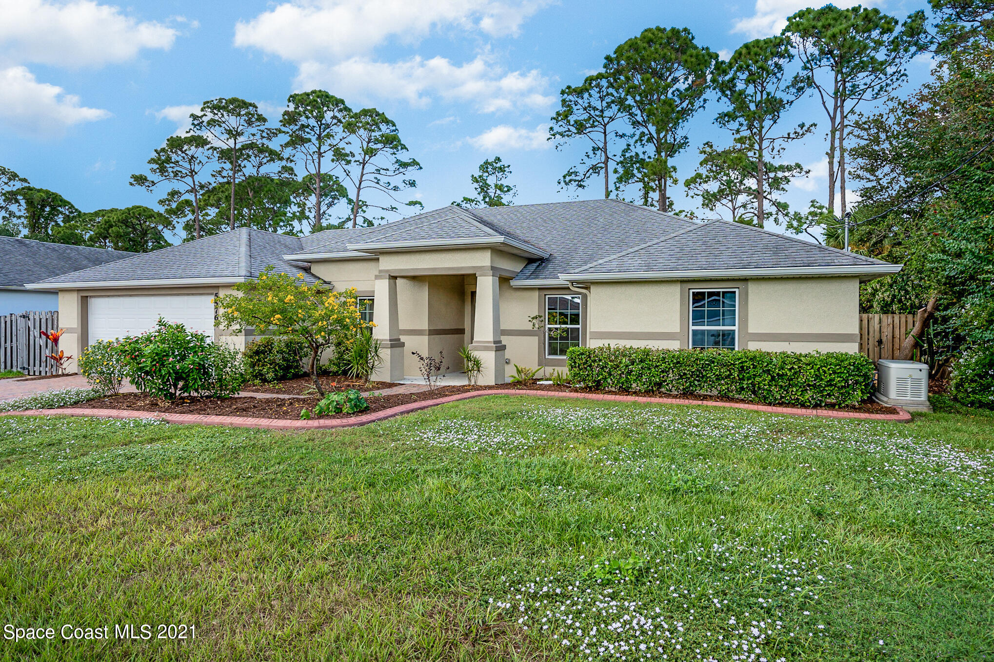5576 Flint Road Cocoa, FL 32927 - Photo 31 of 31 a front view of a house with a yard and garage