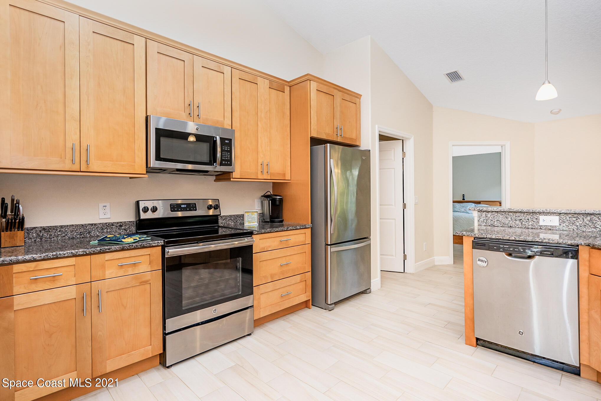 5576 Flint Road Cocoa, FL 32927 - Photo 6 of 31 a kitchen with stainless steel appliances granite countertop a stove a refrigerator and a microwave