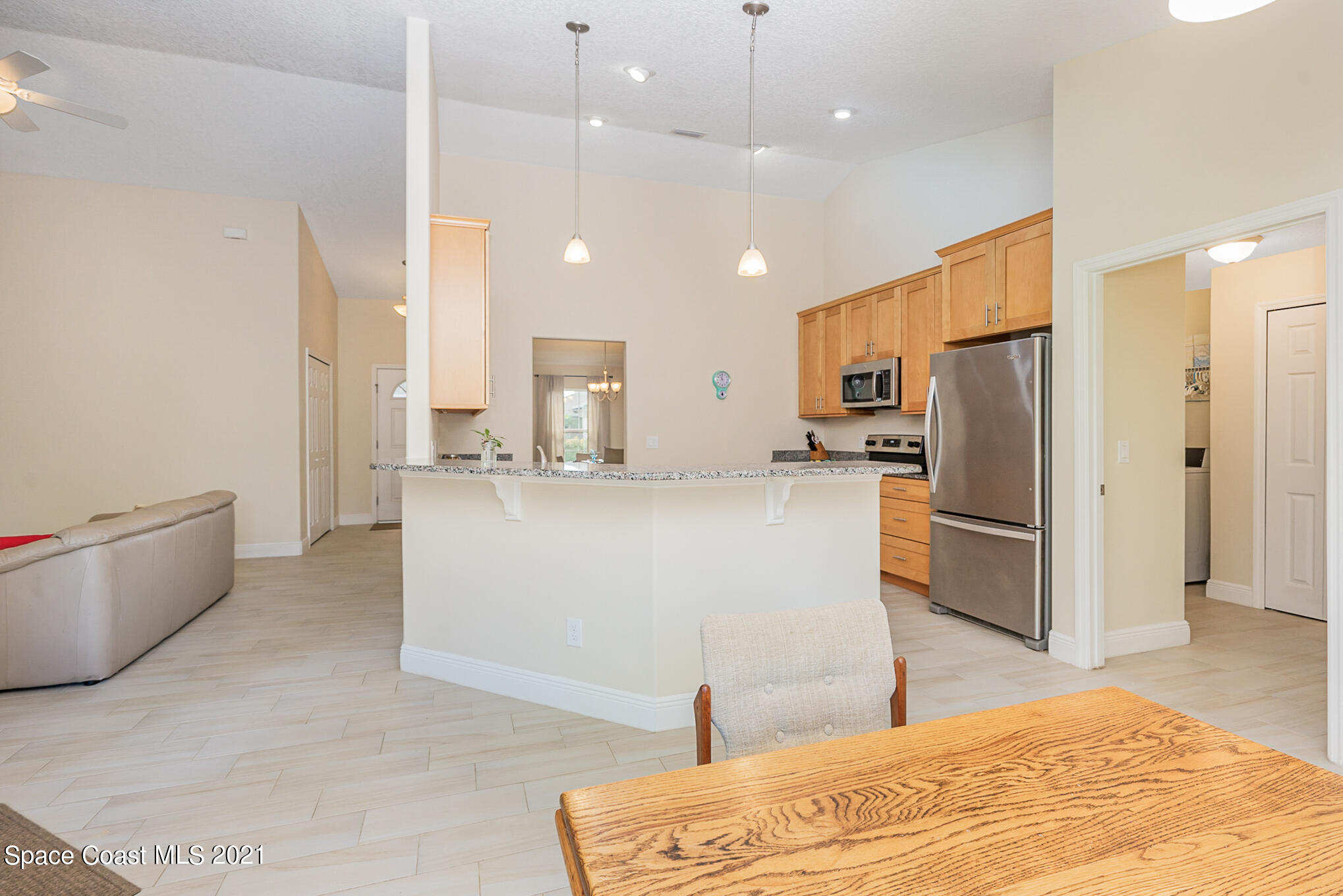 5576 Flint Road Cocoa, FL 32927 - Photo 8 of 31 a kitchen with stainless steel appliances kitchen island a refrigerator sink and stove