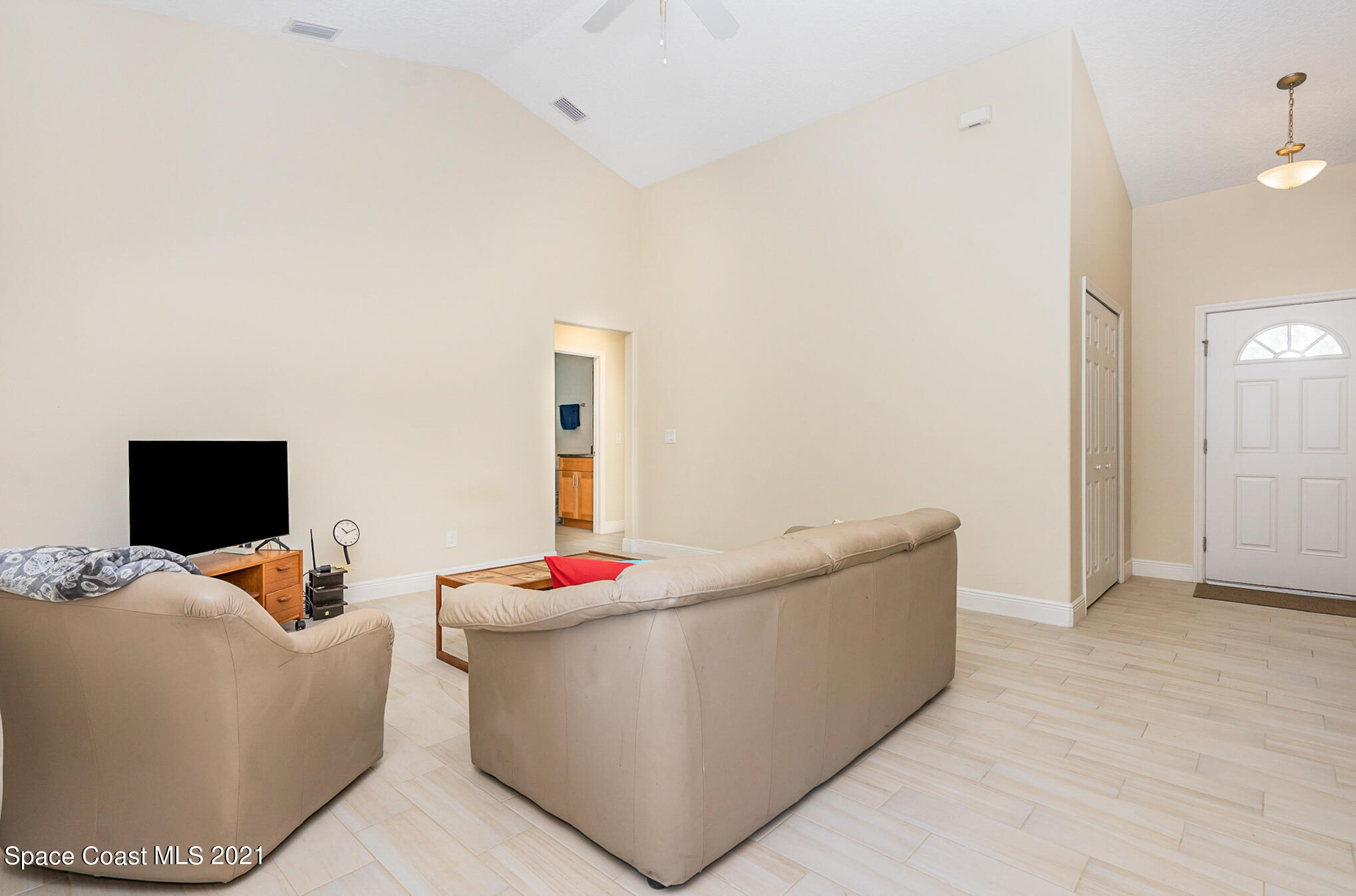 5576 Flint Road Cocoa, FL 32927 - Photo 10 of 31 a living room with furniture and a flat screen tv