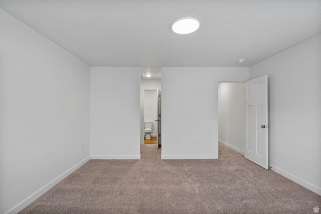 445 950 South Ogden, UT 84404 - Photo 18 of 28 Unfurnished bedroom featuring light colored carpet and connected bathroom