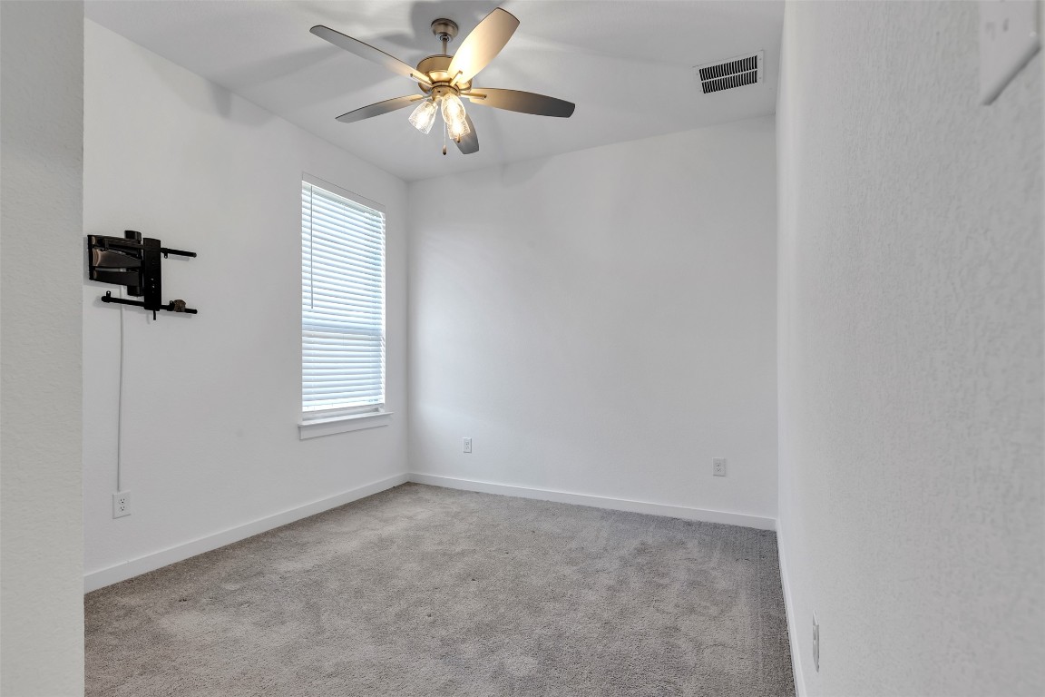 153 Billowing Way Kyle, TX 78640 - Photo 8 of 22 an empty room with windows and fan