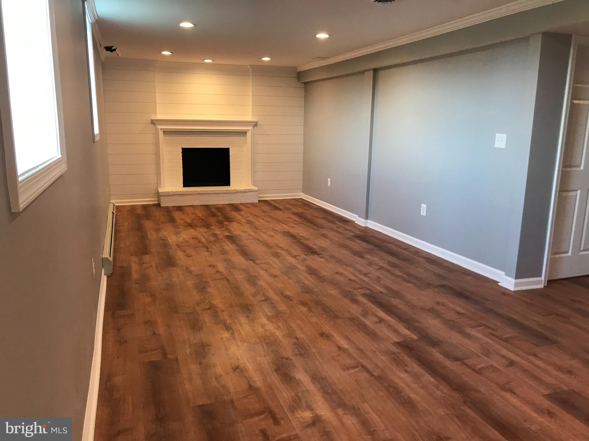 18600 Jerusalem Church Road Poolesville, MD 20837 - Photo 11 of 12 an empty room with wooden floor fireplace and windows