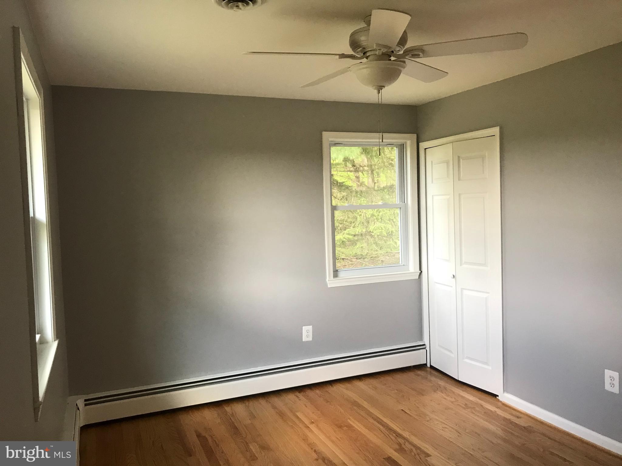 18600 Jerusalem Church Road Poolesville, MD 20837 - Photo 5 of 12 an empty room with a window and a ceiling fan
