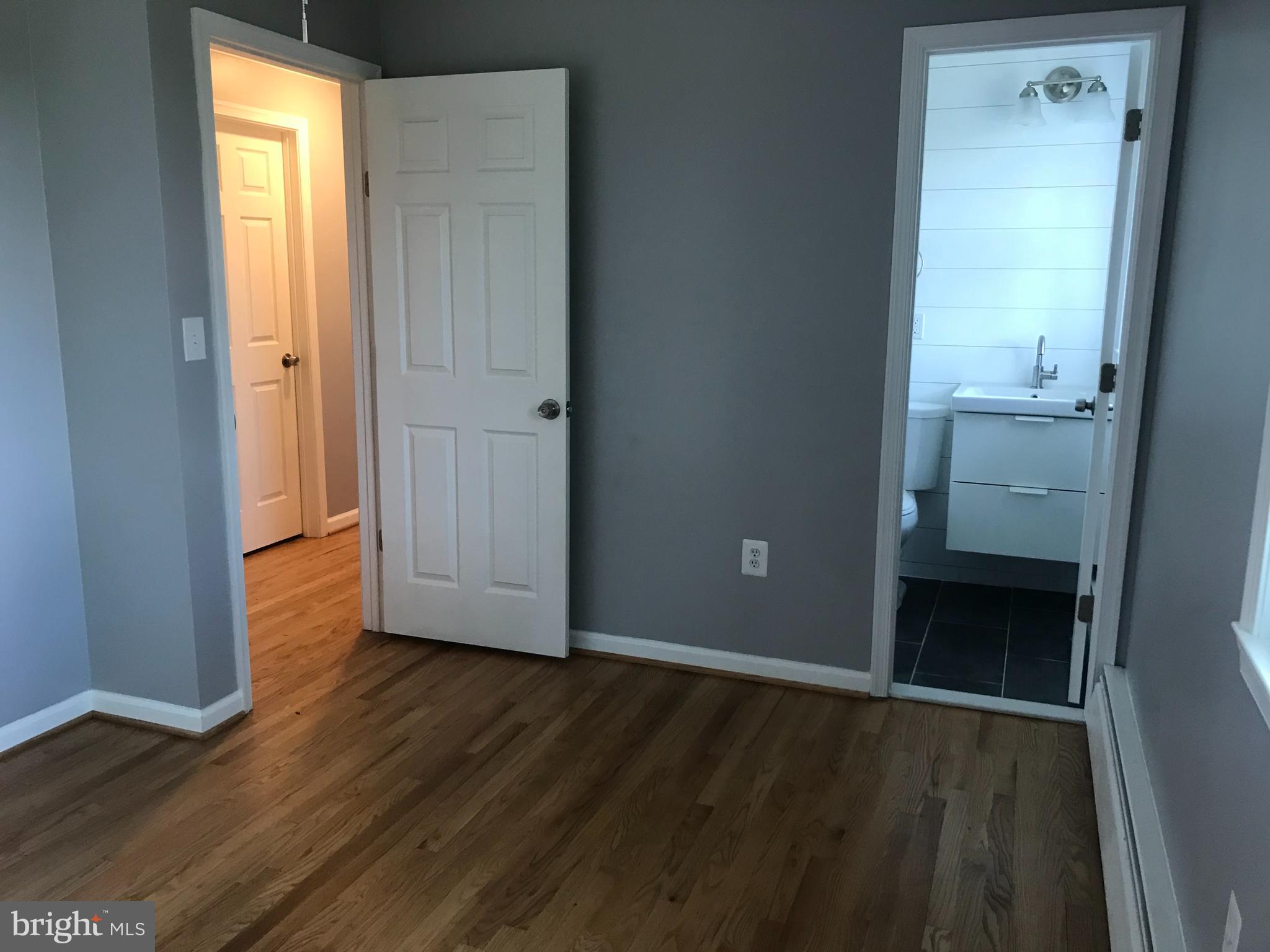 18600 Jerusalem Church Road Poolesville, MD 20837 - Photo 6 of 12 an empty room with wooden floor and windows