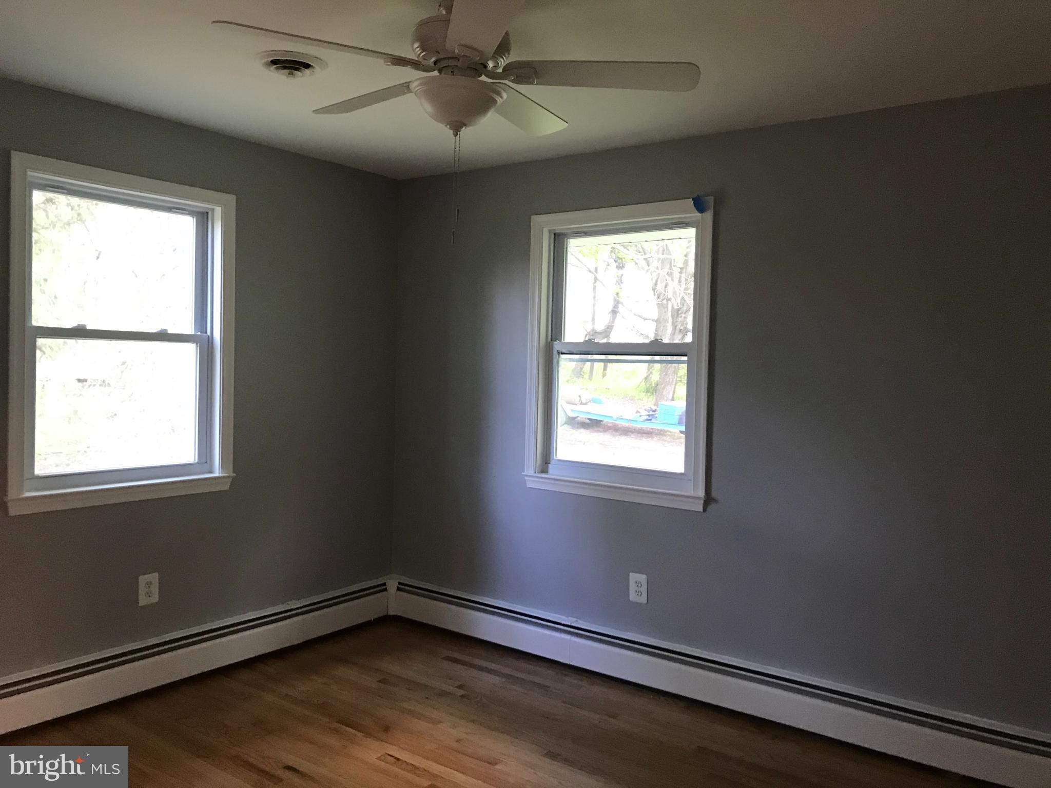18600 Jerusalem Church Road Poolesville, MD 20837 - Photo 9 of 12 a view of an empty room with wooden floor and a window