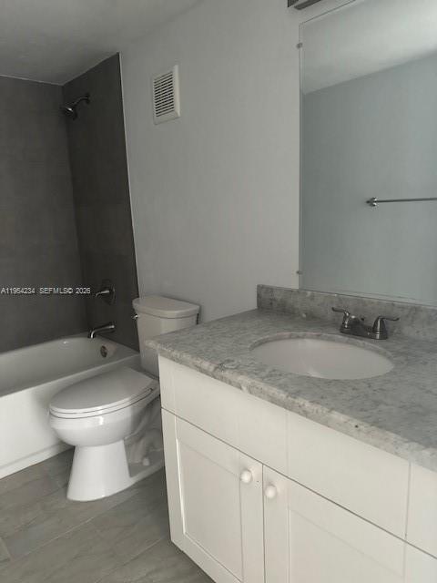 3905 North Nob Hill Road, Unit 304 Sunrise, FL 33351 - Photo 13 of 17 a bathroom with a granite countertop toilet a sink and mirror
