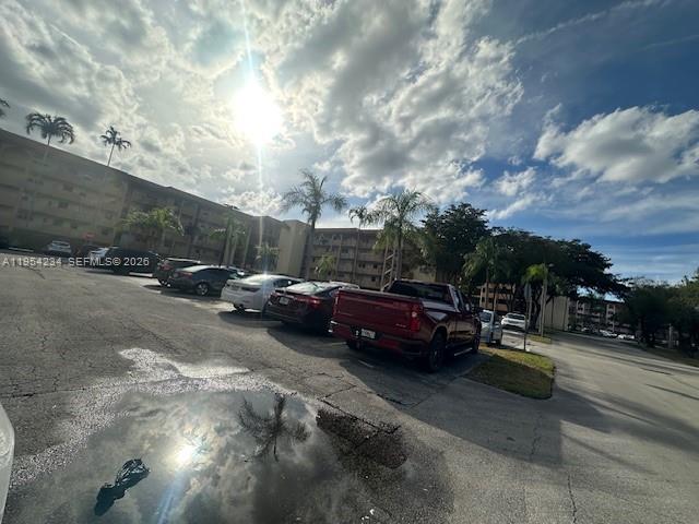 3905 North Nob Hill Road, Unit 304 Sunrise, FL 33351 - Photo 16 of 17 a view of street with parked cars