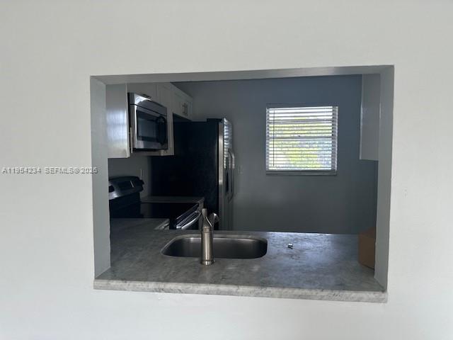 3905 North Nob Hill Road, Unit 304 Sunrise, FL 33351 - Photo 4 of 17 a bathroom with a sink a mirror and a window