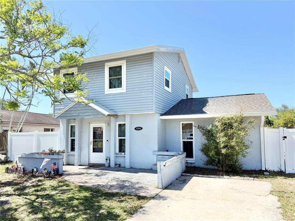 1784 Taylor Lake Place Largo, FL 33778 - Photo 1 of 24 a front view of a house with a yard