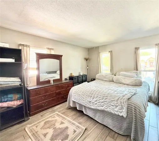 a bedroom with a bed and a dresser with mirror