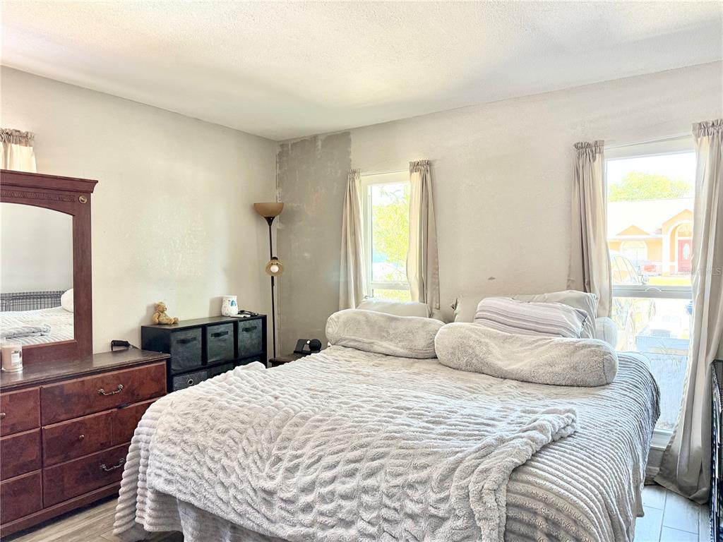 1784 Taylor Lake Place Largo, FL 33778 - Photo 13 of 24 a bedroom with a bed and wooden floor