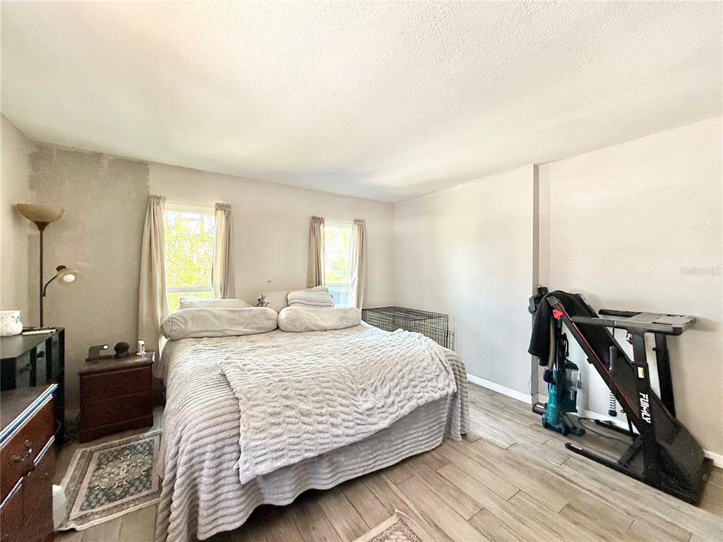 1784 Taylor Lake Place Largo, FL 33778 - Photo 14 of 24 a bedroom with a bed and a view of living room