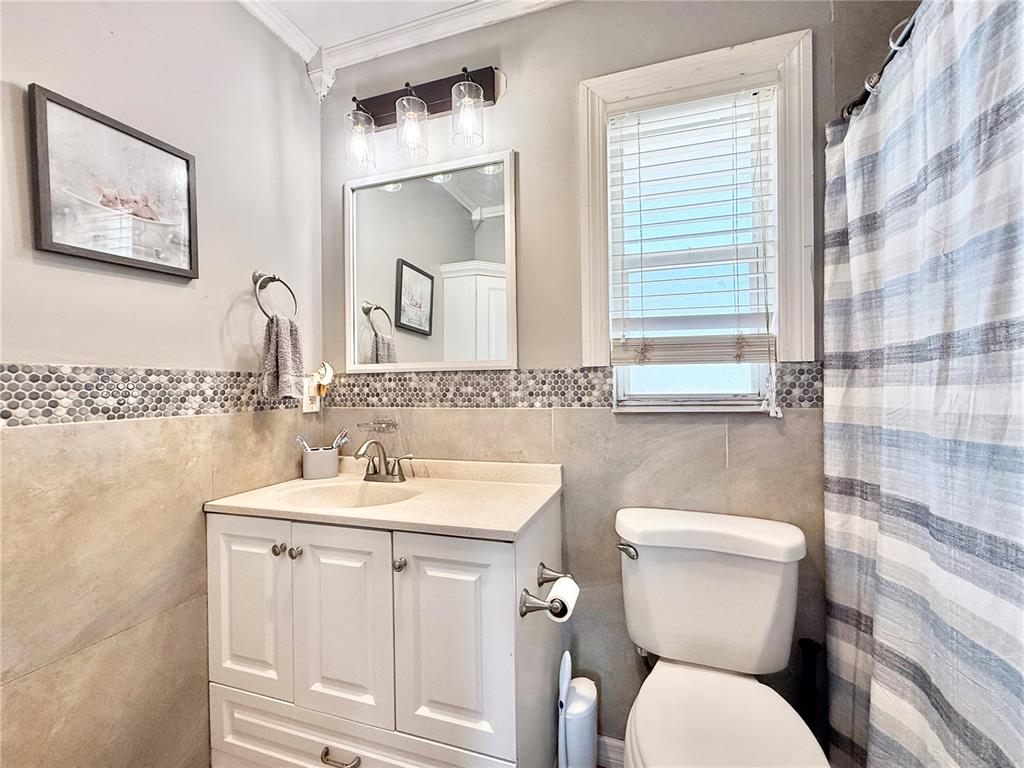 1784 Taylor Lake Place Largo, FL 33778 - Photo 16 of 24 a bathroom with a toilet sink and mirror