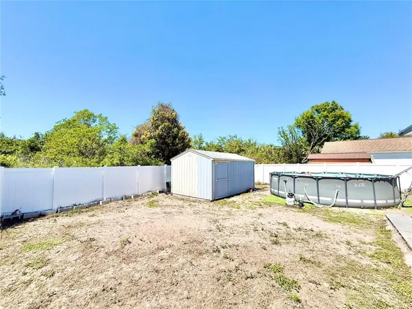 a backyard of a house with large trees