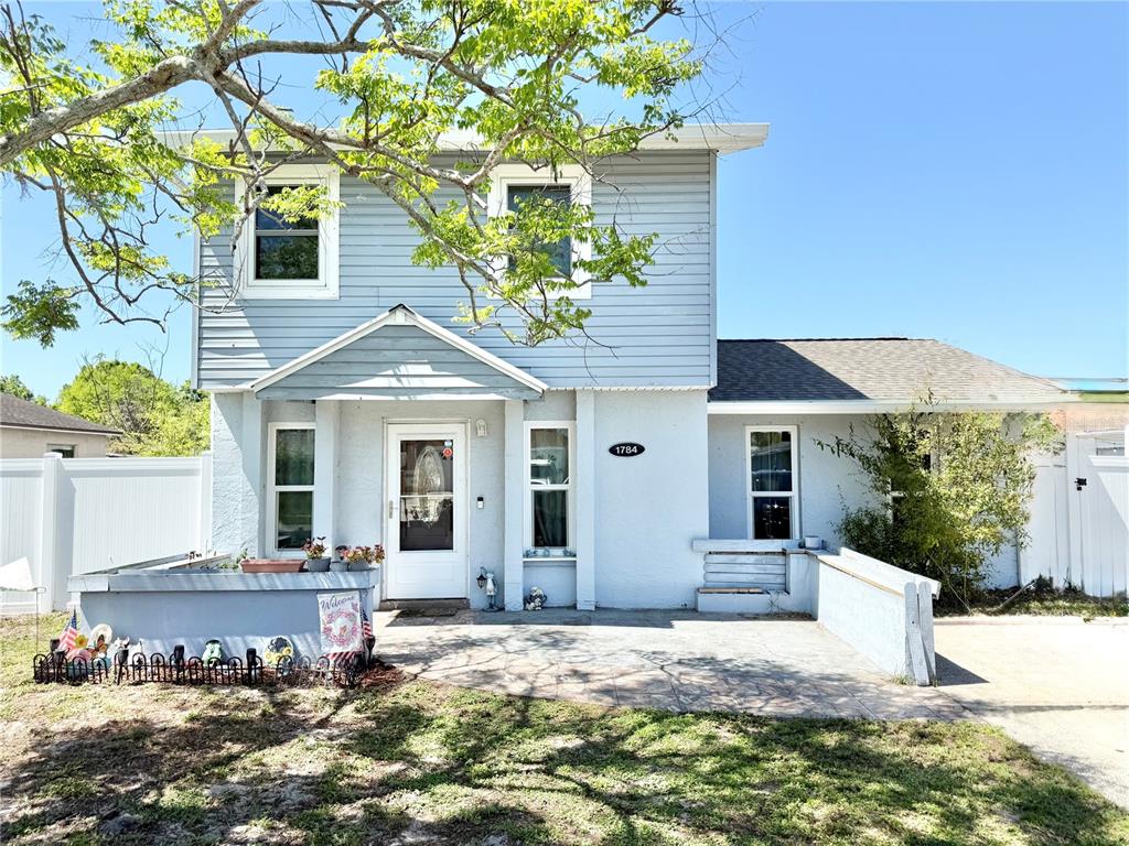 1784 Taylor Lake Place Largo, FL 33778 - Photo 2 of 24 a front view of a house with garden
