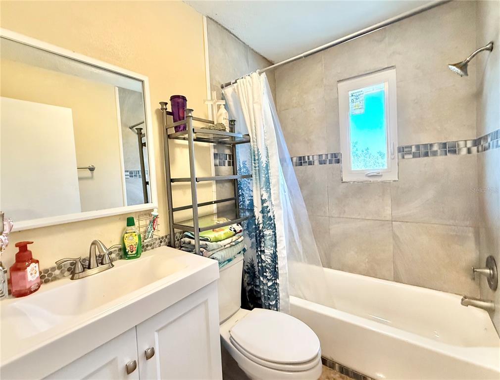 1784 Taylor Lake Place Largo, FL 33778 - Photo 24 of 24 a bathroom with a sink a toilet and a bathtub