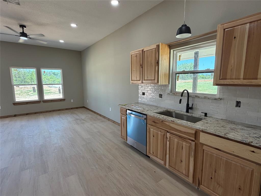 1040 Rays Way Weatherford, TX 76085 - Photo 10 of 23 Open-concept living space featuring wood-finish flooring, recessed lighting, and a ceiling fan