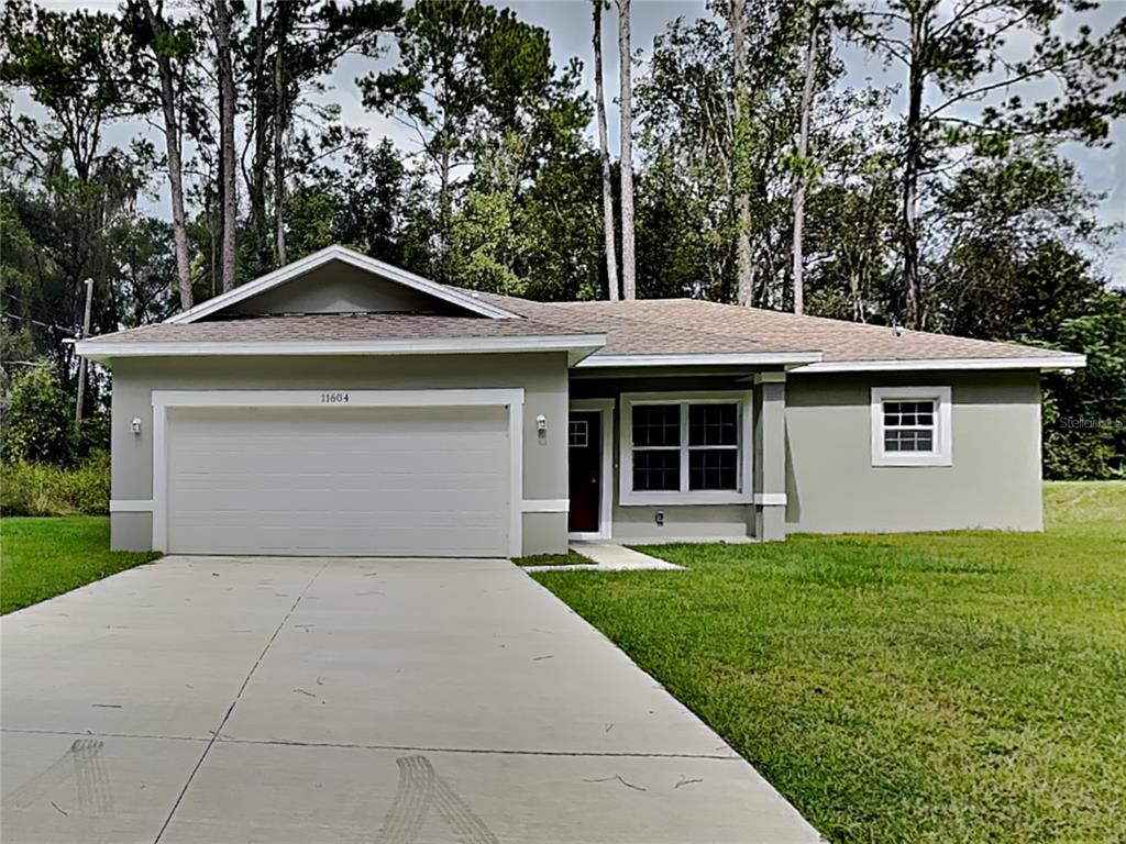11604 North Kenlake Circle Citrus Springs, FL 34434 - Photo 1 of 15 a front view of a house with yard