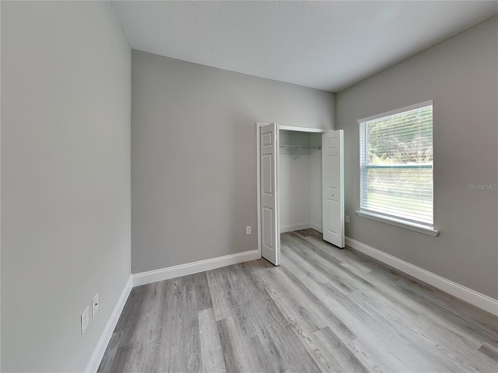 11604 North Kenlake Circle Citrus Springs, FL 34434 - Photo 11 of 15 an empty room with wooden floor and windows