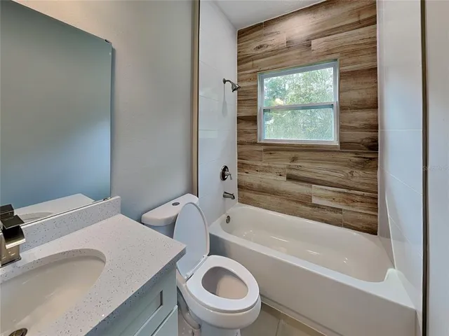 a bathroom with a sink a toilet and a bathtub