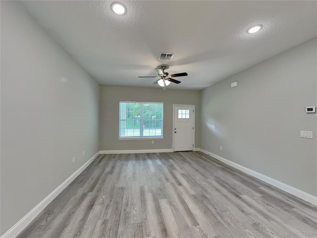 11604 North Kenlake Circle Citrus Springs, FL 34434 - Photo 2 of 15 wooden floor in an empty room with a window