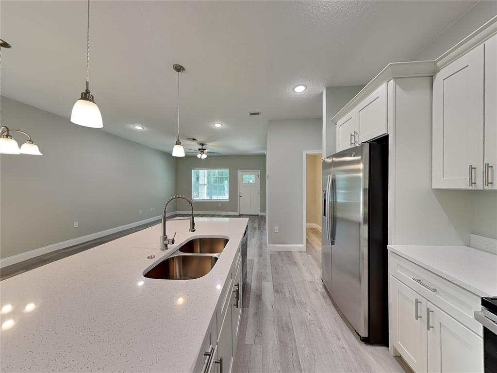 11604 North Kenlake Circle Citrus Springs, FL 34434 - Photo 3 of 15 a kitchen with a sink a refrigerator and window