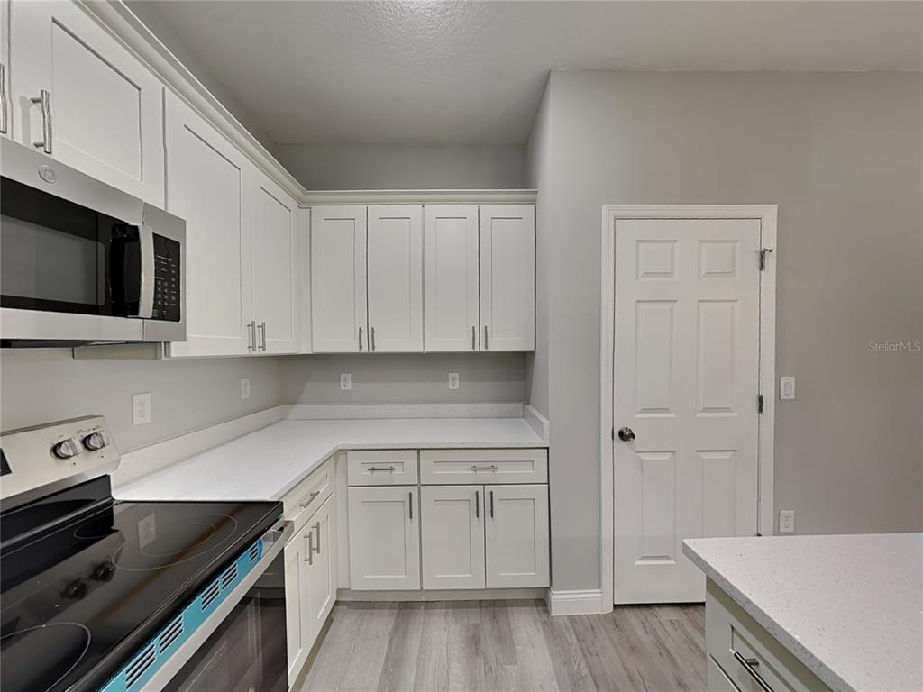 11604 North Kenlake Circle Citrus Springs, FL 34434 - Photo 4 of 15 a kitchen with white cabinets and sink