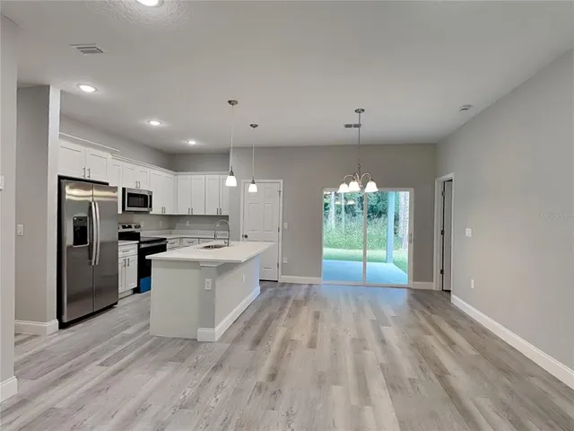 a view of a kitchen with a sink and a window