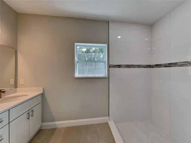 a bathroom with a shower and a sink