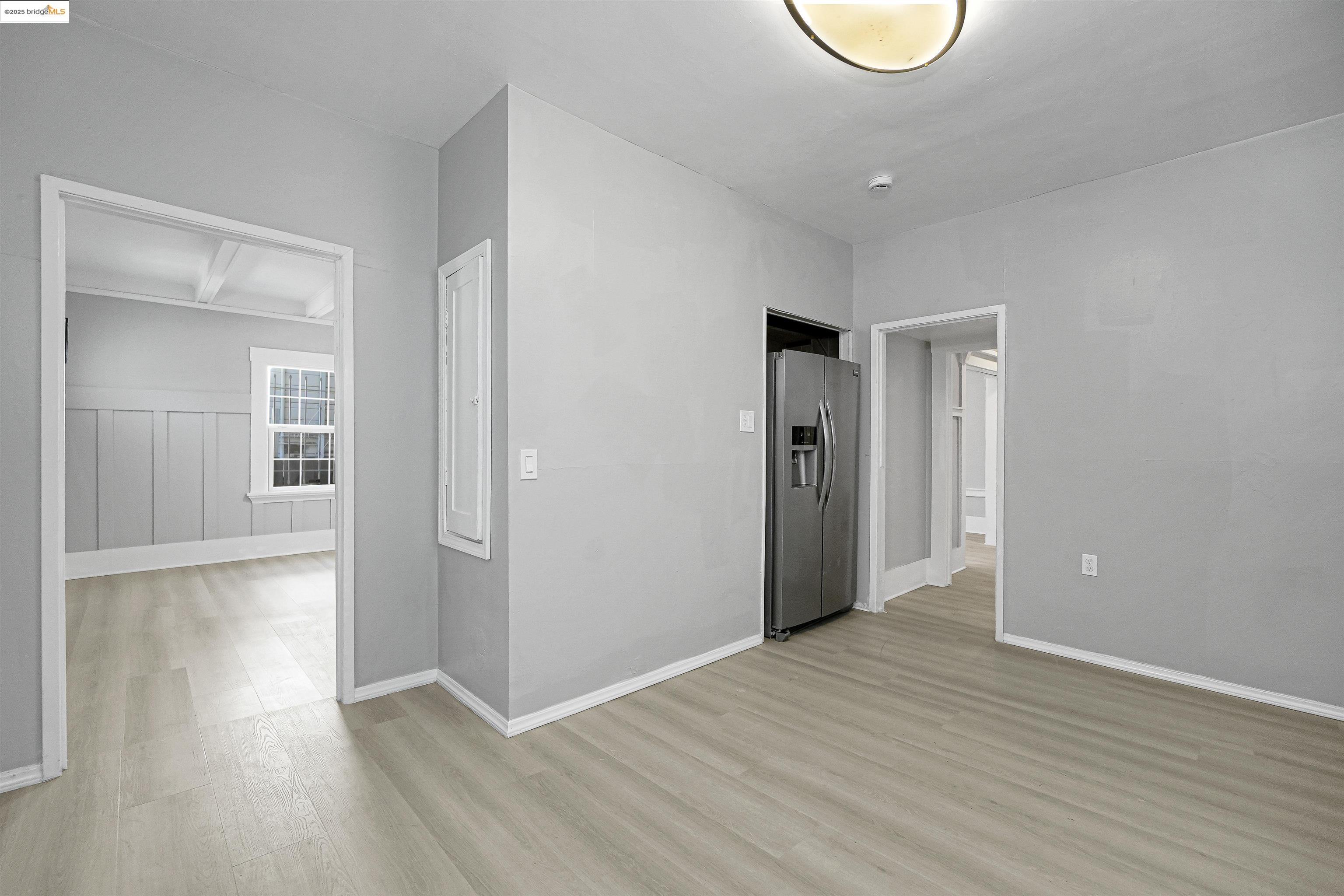 2207 East 19th Street Oakland, CA 94606 - Photo 11 of 30 a view of a room with wooden floor and white walls