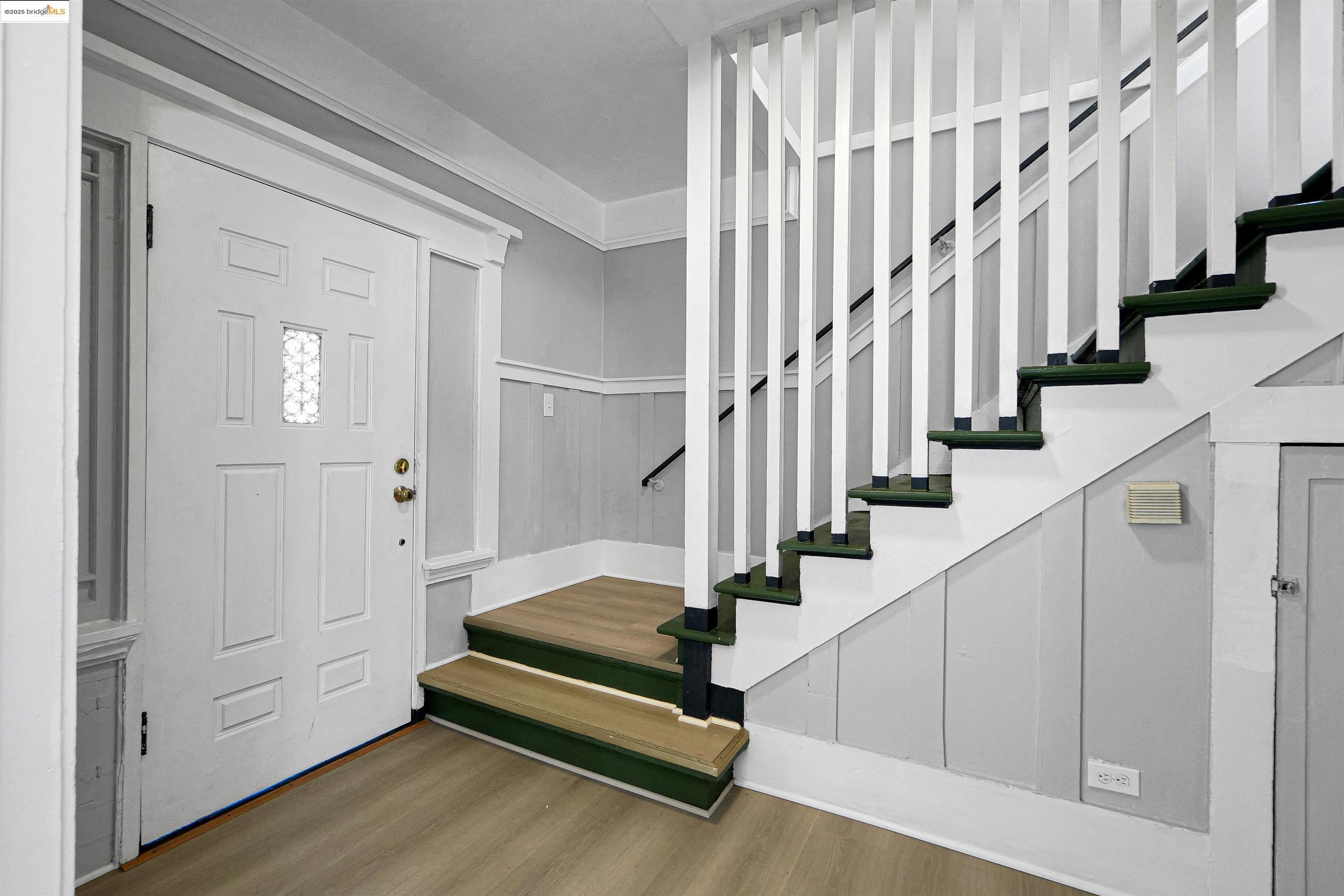 2207 East 19th Street Oakland, CA 94606 - Photo 13 of 30 a view of entryway with wooden floor and stairs