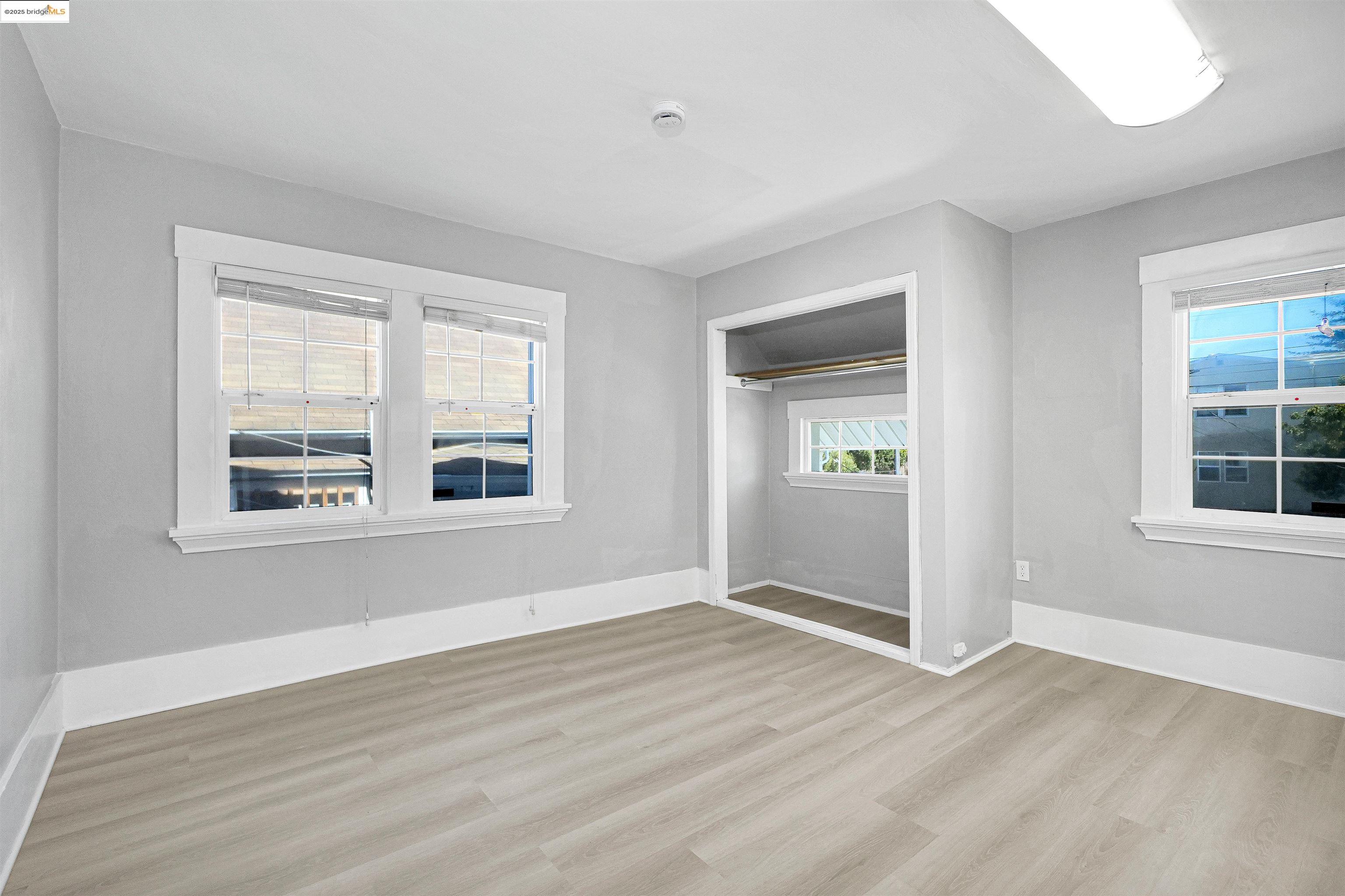 2207 East 19th Street Oakland, CA 94606 - Photo 14 of 30 a view of an empty room with wooden floor and a window