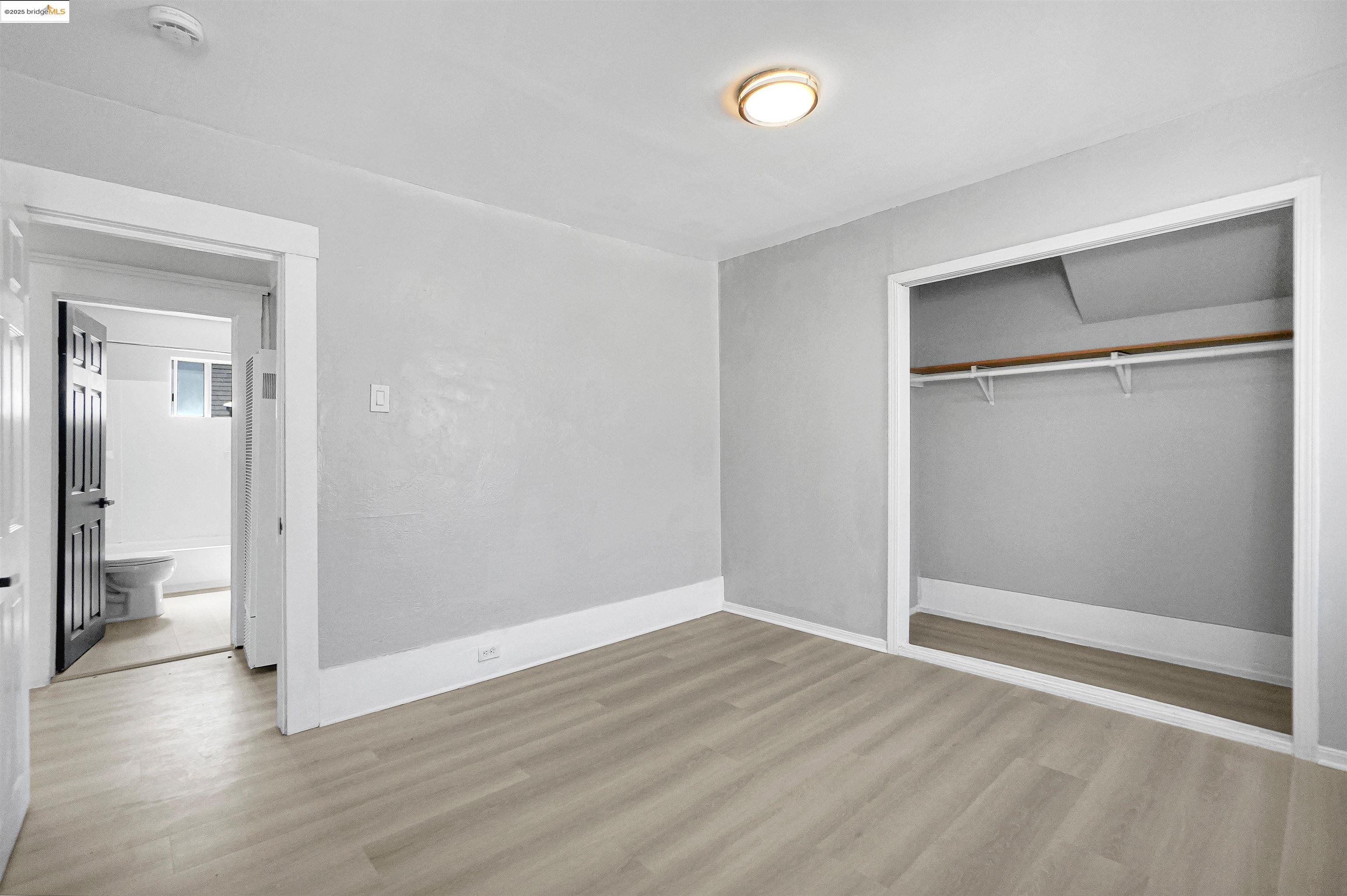 2207 East 19th Street Oakland, CA 94606 - Photo 19 of 30 a view of empty room with wooden floor