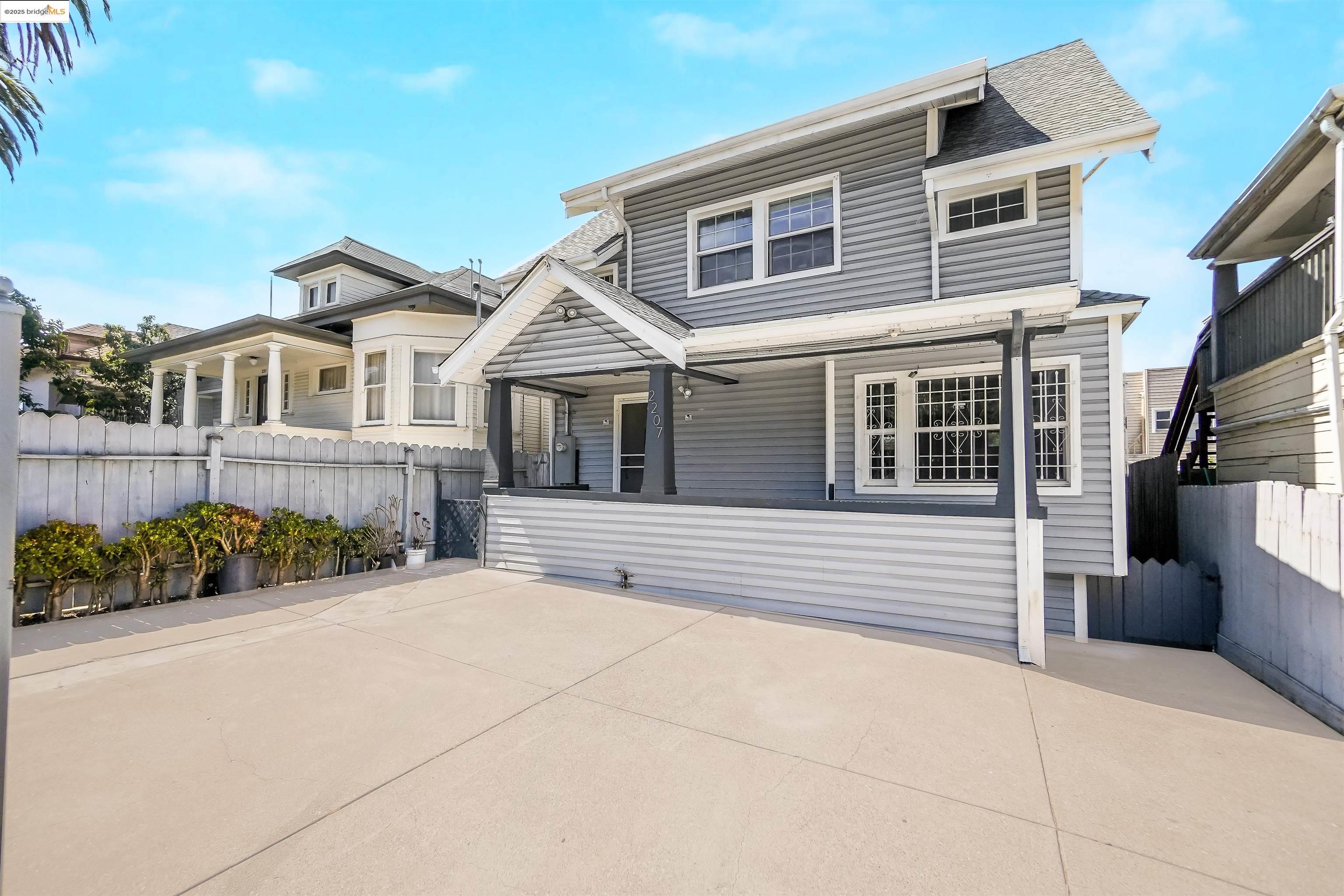 2207 East 19th Street Oakland, CA 94606 - Photo 2 of 30 a front view of a house with a garden