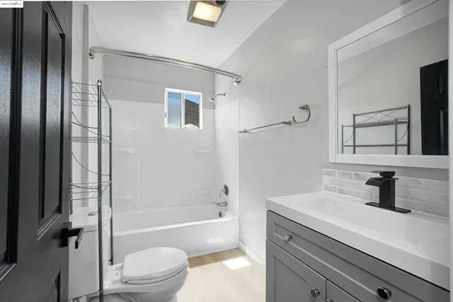 a view of a hallway with entryway and wooden floor